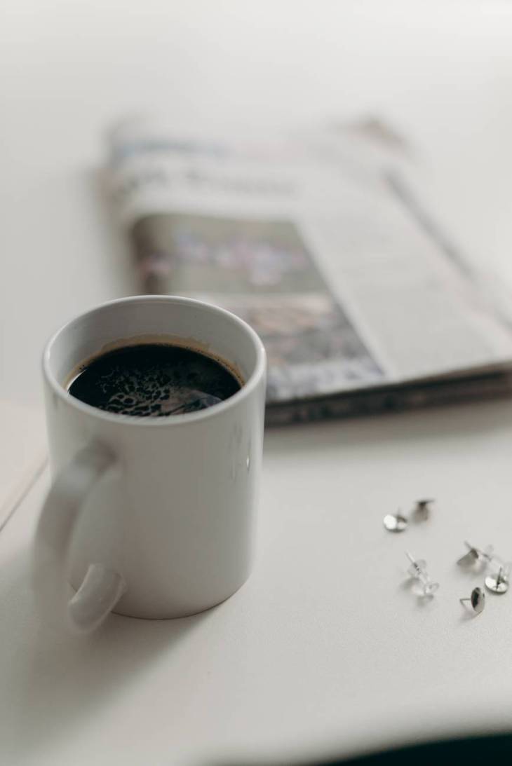 white ceramic mug on white table